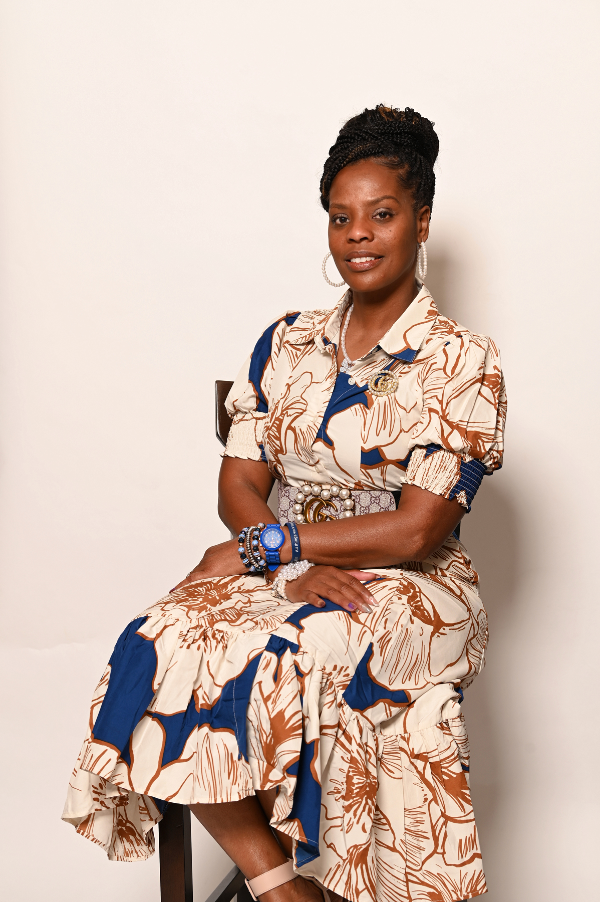 First Lady Tamecia Smith smiling warmly, standing in a welcoming church environment with soft lighting and gentle colors, conveying a sense of kindness and encouragement